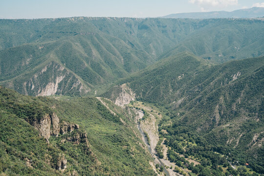 Deep valley in huasca de ocampo, hidalgo, mexico, featuring mountains, lush vegetation, and a river
