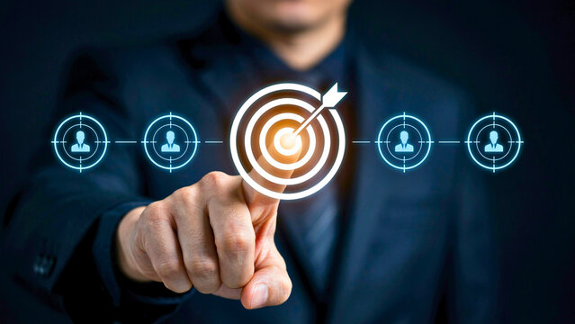 Businessman pointing at virtual target icon for audience profiling and business marketing strategy