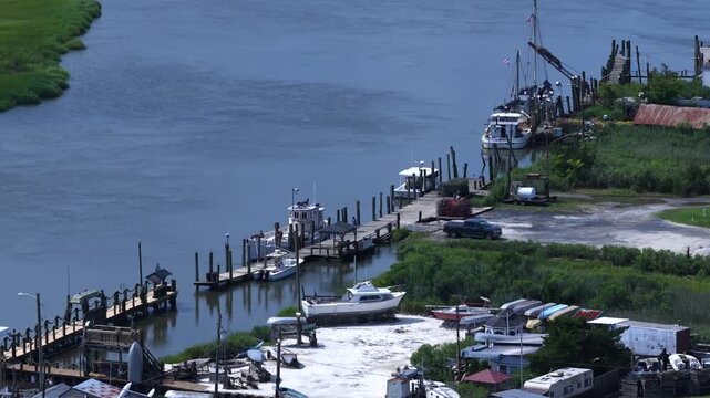 Small fishing community on Delaware coastline at Bowers Beach with marina and inlet waterway with natural wetlands