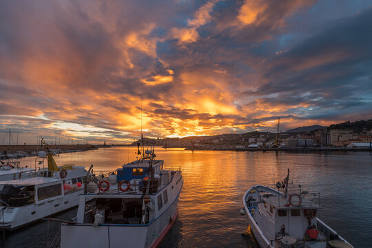Colorful sunset with cityscape silhouette. Imperia, Italy