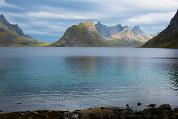 Mountains by the sea with blue sky and white clouds in Lofoton Norway © Hubert