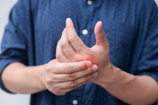 close up employee man massage on his hand and arm for relief pain from hard working ,carpal tunnel syndrome concept
