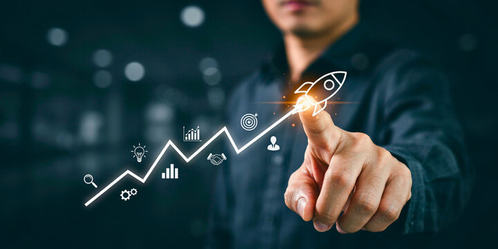 Illustrating business growth with a rocket launching upwards on a digital graph, symbolizing startup success and progress