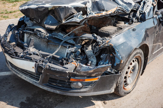 Car crash wreck collision accident damage vehicle safety insurance salvage concept, showing crushed hood, exposed engine, broken bumper, twisted metal and severe impact.