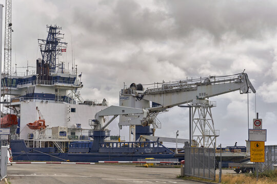 Esbjerg, Denmark - 27 July 2026: View of the MSV Botnica icebreaker docked at the port, featuring its large crane, industrial deck equipment, and blue and white hull under a cloudy sky.
