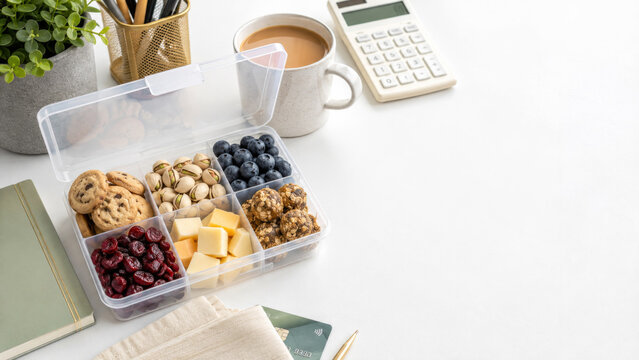 Snackle box with various snacks on white table, concept for office lunch