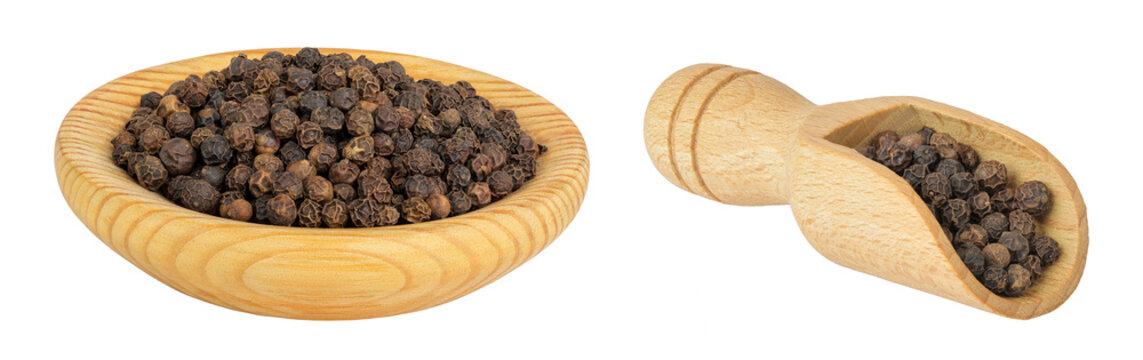 Black peppercorns or pepper in a wooden bowl and scoop isolated on a white background