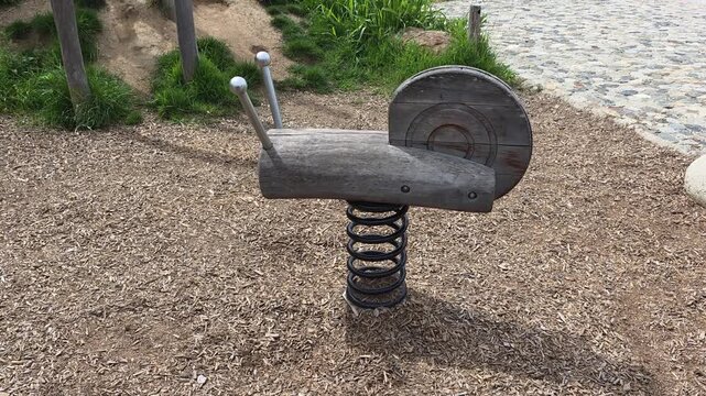 Snail-shaped spring rider for children