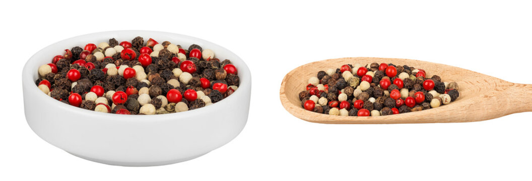 Pepper mix in a ceramic bowl and wooden spoon isolated on white background.