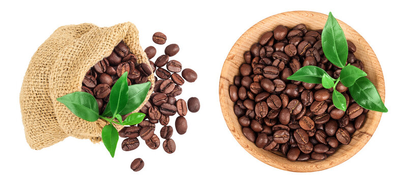 Coffee beans in burlap bag and wooden bowl with leaf isolated on white background. Top view. Flat lay