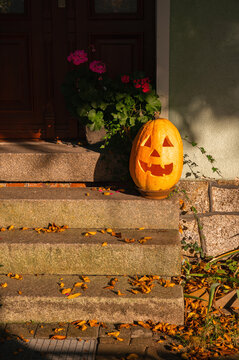 Carved Halloween jack o lantern pumpkin on stone steps