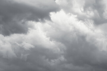 Fototapeta premium Dramatic dark gray overcast cloudy sky. Concept of approaching rain storm, gloomy weather, moody atmosphere, climate and environment.