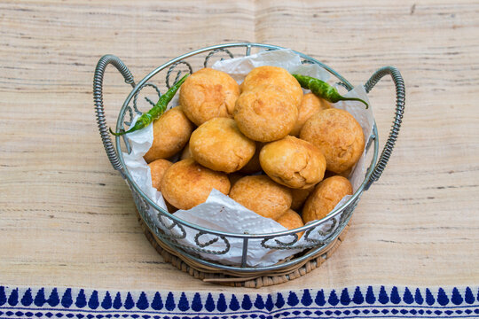 Kachodi with fried green chilli served in a basket, indian famous snacks during diwali. 