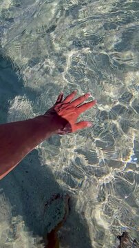Feel the refreshing touch of crystal-clear waters as hands glide through the gentle waves. Simos Beach on Elafonisos Island offers a serene escape for travelers seeking tranquility in Greece