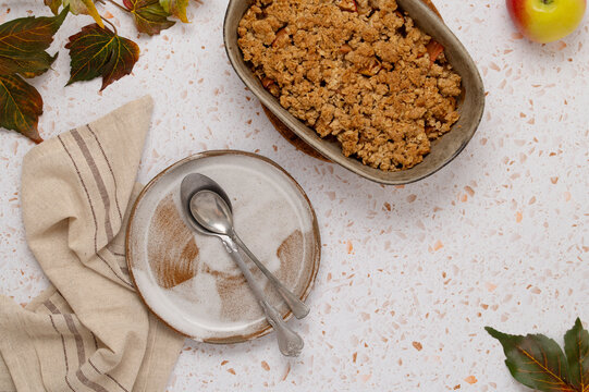 Apple oat crumble dessert on terrazzo table