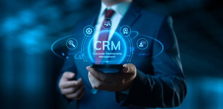 Businessman holding smartphone with CRM Customer Relationship Management icons on screen