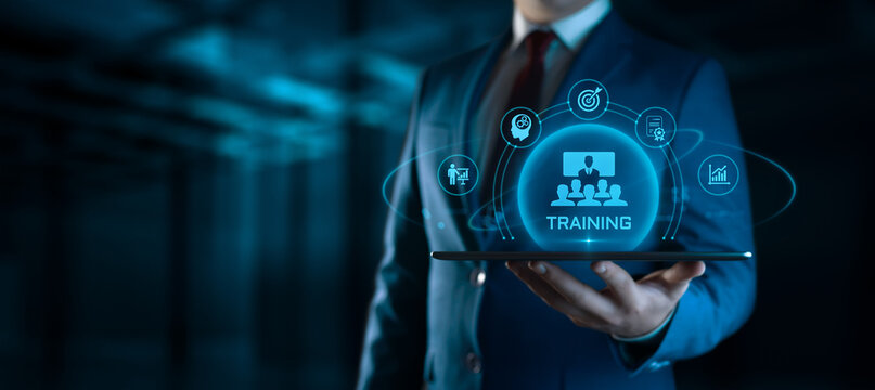 Businessman Holding tablet with Training Icons on Screen. E-Learning and online Education concept