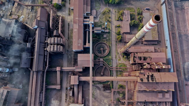 Aerial view of Smederevo Steelworks featuring industrial chimneys, circular water treatment tanks, complex pipe networks, and metallic rooftops in Smederevo, Podunavlje District, Serbia.