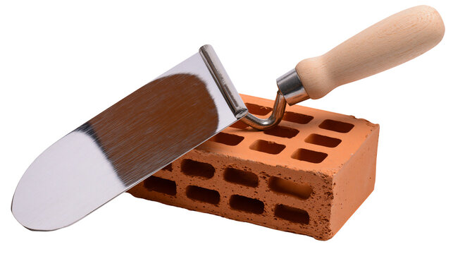 Trowel tool resting on hollow clay brick