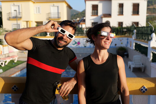 couple with glasses ready for see solar eclipse in chalet terrace