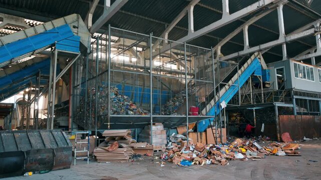 Industrial sorting line at municipal waste management facility for processing domestic garbage.