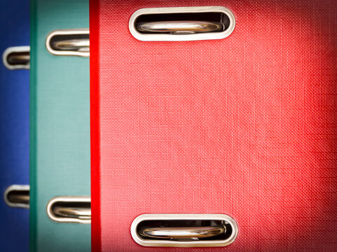 Row of colorful ring binder folders for office organization and document storage