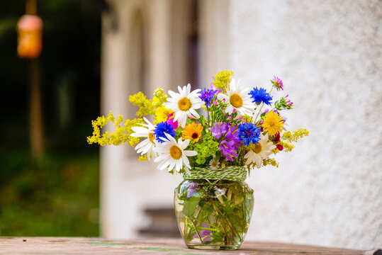 Beautiful bouquet with summer wild flowers and margaritas on green background	