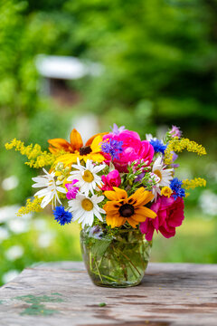 Beautiful bouquet with summer wild flowers and margaritas on green background	