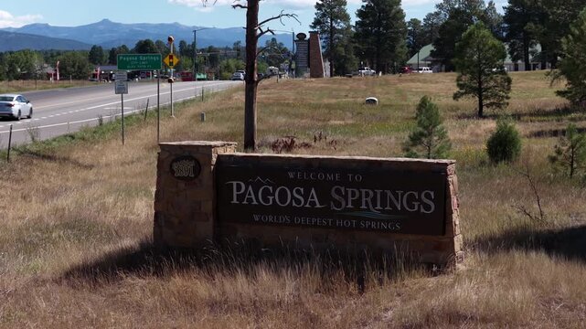 Summer aerial of Pagosa Springs Colorado entrance sign and highway 160 with dry grassland with prominent welcome sign