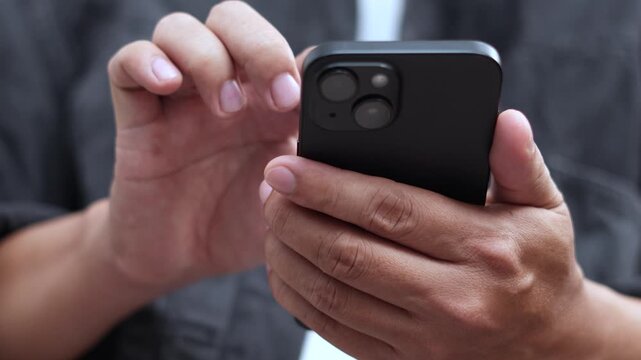 man holds smart phone in her hands and scrolls through the news feed. Close up of hand uses mobile. point finger on screen, texting text message.