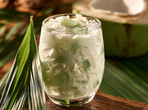 Creamy Buko Pandan featuring a fragrant pandan aroma, a blend of young coconut, pandan jelly, and ice, served chilled in a glass with a tropical vibe.