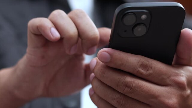 man holds smart phone in her hands and scrolls through the news feed. Close up of hand uses mobile. point finger on screen, texting text message.