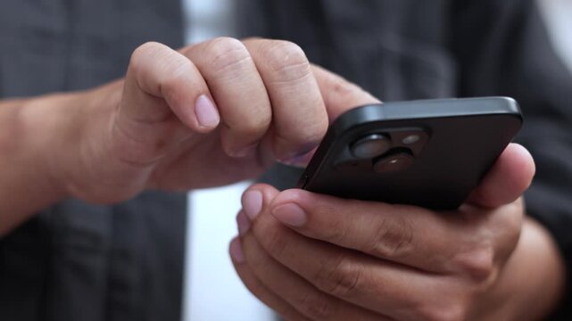 man holds smart phone in her hands and scrolls through the news feed. Close up of hand uses mobile. point finger on screen, texting text message.