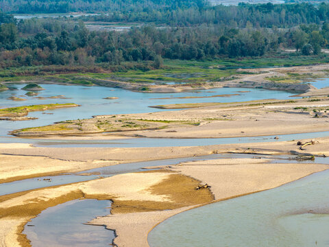Aerial view of the Drina River featuring extensive sandbanks, shallow water channels, and surrounding lush vegetation in Crna Bara, Macva District, Serbia.