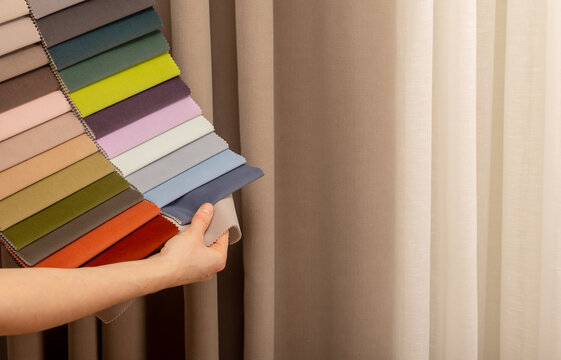 Upholstery fabric swatch fan presentation in showroom studio. Specialist demonstrating soft velour