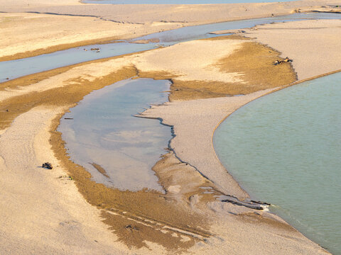 Aerial view of the Drina river with exposed sandbanks and shallow water channels in Crna Bara, Macva District, Serbia.