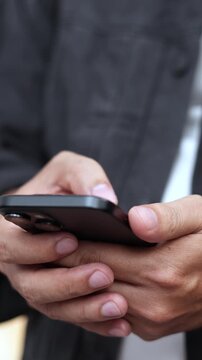 man holds smart phone in her hands and scrolls through the news feed. Close up of hand uses mobile. point finger on screen, texting text message.