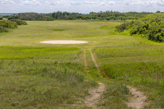 Scenic Golf Fairway Through Natural Grassland with Sand Bunker and Tree-Lined Prairie Landscape at Pike Lake Provincial Park, Saskatchewan, Canada