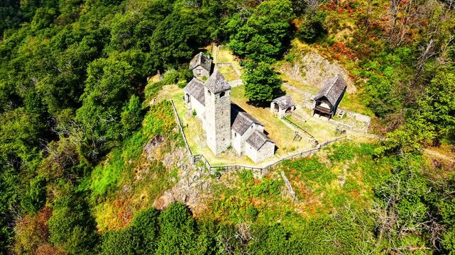 drone flying at old Chiesa di San Bernardo perched on mountain 