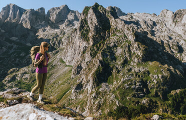 Naklejka premium Female Backpacker Navigating Rocky Path in Balkan Mountains