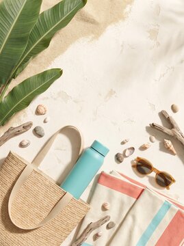Summer vacation flat lay items on white sand beach background