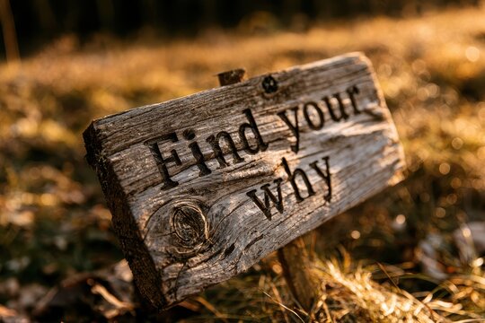Find your why: Motivational message on a weathered wooden sign outdoors