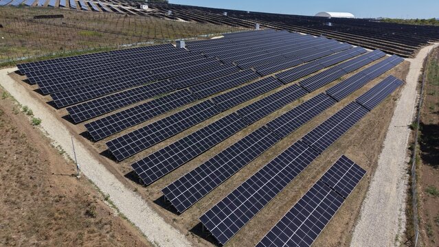 Aerial view of solar power plant 9.9 MW with rows of photovoltaic panels installed in a rural field in Lapovo, Sumadija District, Serbia.