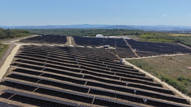 Aerial view of the 9,9 MW solar power plant featuring rows of photovoltaic panels in a rural landscape in Lapovo, Sumadija District, Serbia.
