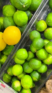 Unripe or green lemons are neatly arranged in the kitchen's spice storage area.
