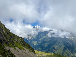 Naklejka premium Clouds over mountain slopes of Mont Blanc massif, France