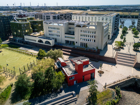 Aerial view of Baakenhafen in the Hafencity featuring modern architecture and a nearby soccer field in Hamburg, Germany.