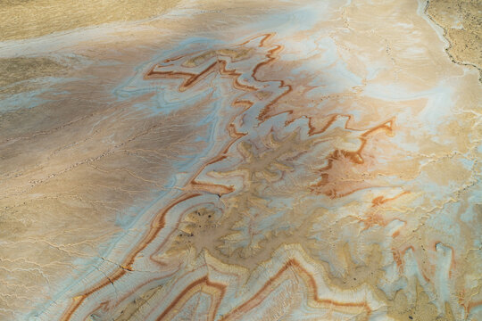 Aerial view of the striking geological formations and colorful sedimentary layers of the Bozhira landscape in the Karakiya District, Mangystau Region, Kazakhstan.