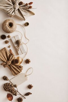 Sustainable gift wrapping with fabric and twine on beige background. Zero waste present packaging for autumn holiday. Eco friendly christmas gift box with dried nature decoration.