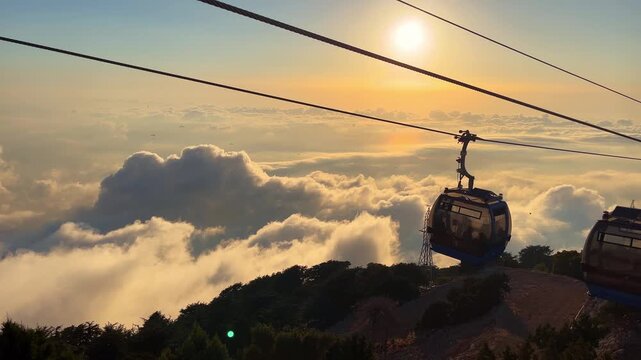 Cable cars floating above a sea of clouds during sunset on Babadag Mountain in Fethiye, Turkey, with stunning panoramic views and golden evening light.